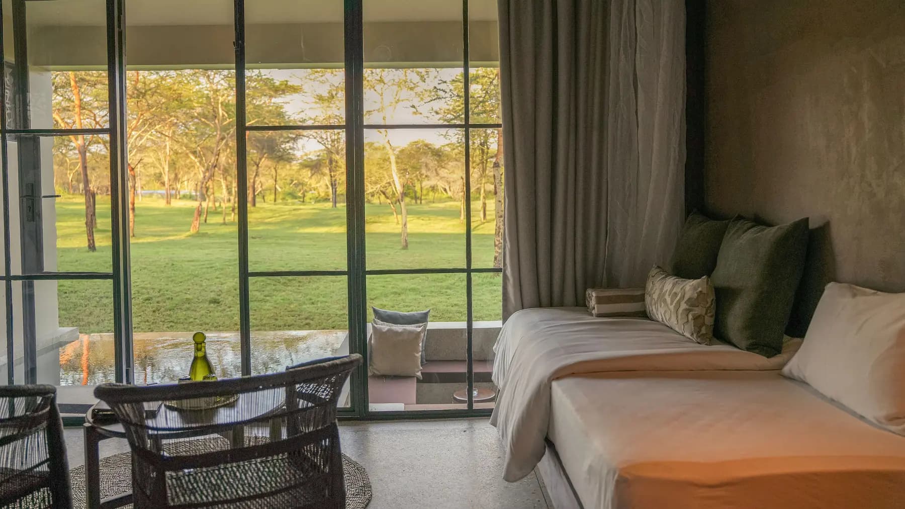 Guest room with lounge seating and garden views