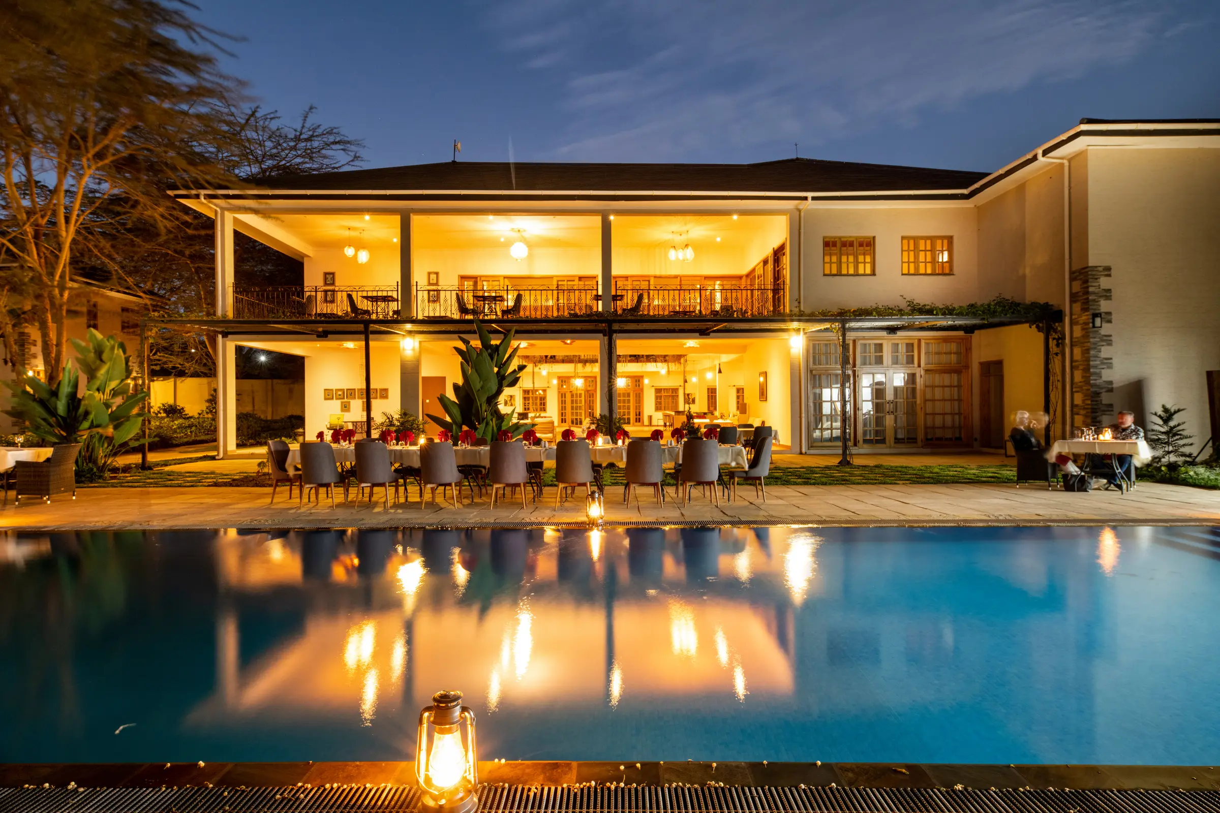 Kahawa House pool and lit terrace at dusk