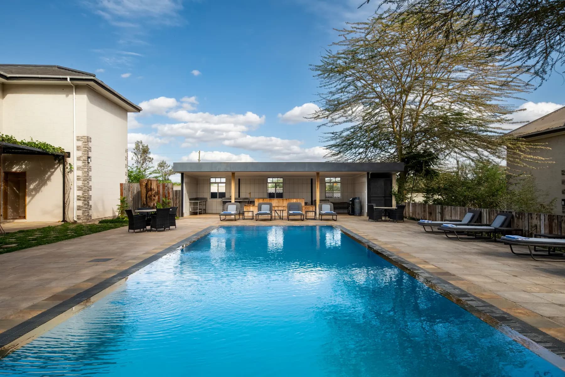 Swimming pool with loungers on a sunny day