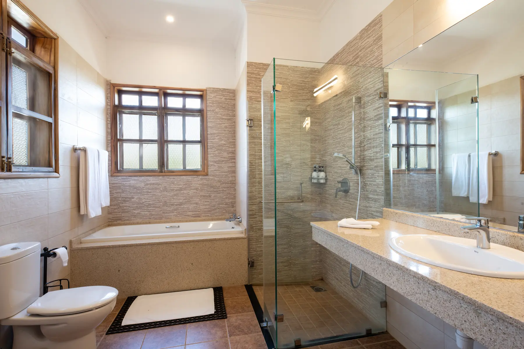 Bathroom with bathtub and glass shower