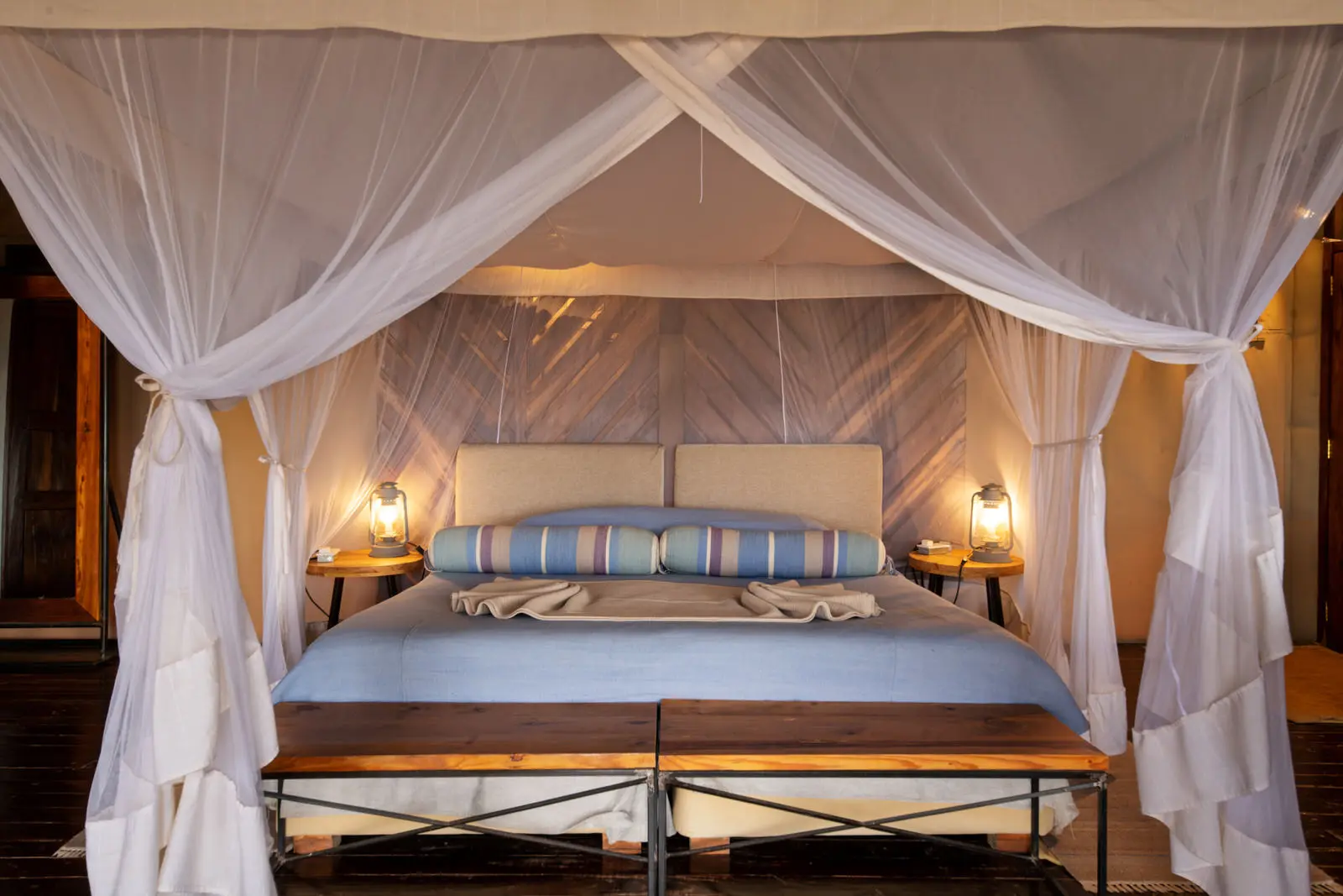 Tent bedroom with four-poster bed and mosquito net