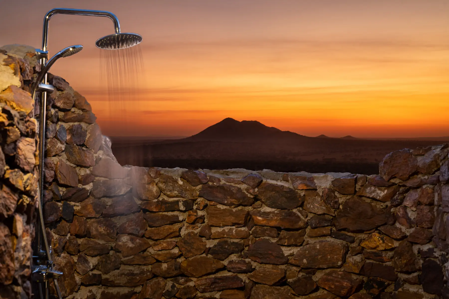 Open-air shower facing a Serengeti sunset