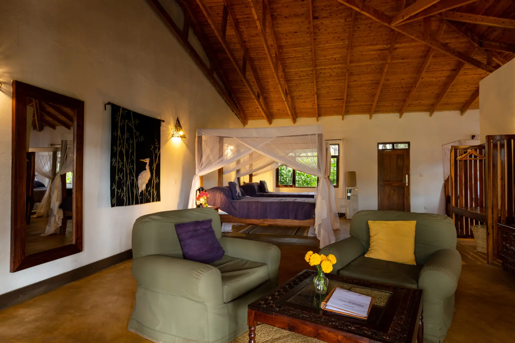 Guest room with timber ceiling and lounge chairs